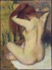 Nude woman combing her hair reproduction by Degas adds subtle elegance to an artistic interior.