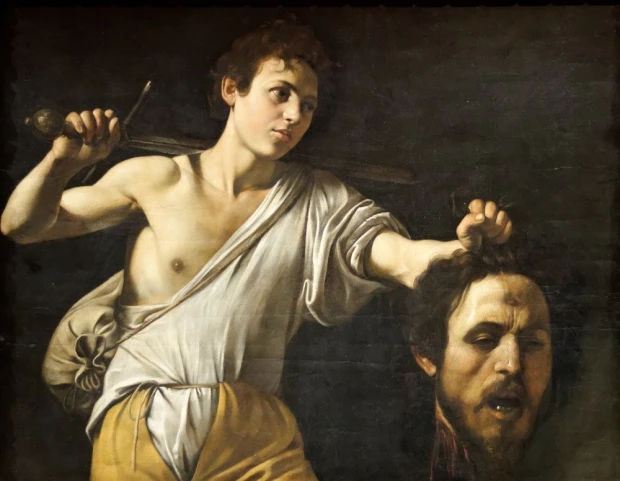 Reproduction of David with Goliath\'s head, Michelangelo Caravaggio - Graphic design. A young man holding the head in one hand.