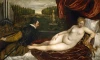 Reproduction of Venus with an organist and a small dog by Titian. A nude woman reclines on a sofa beside them.