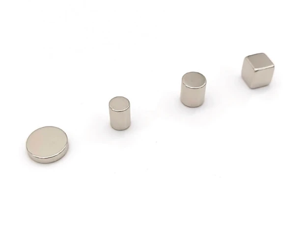 Set of 5 neodymium magnets in various sizes and shapes: round and cylindrical with graphic design.