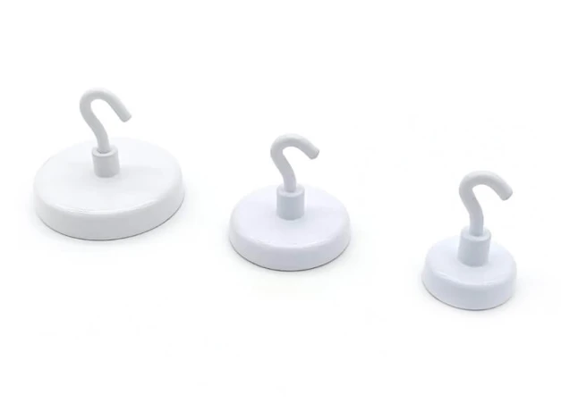 Magnet with hook in various sizes - Three round white magnets with hooks and graphic design.