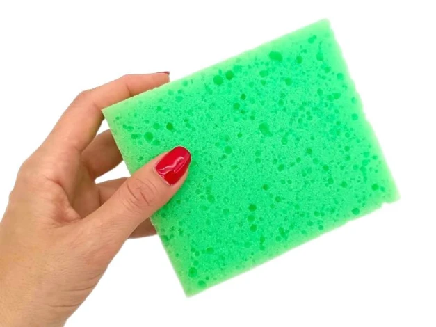 Chalkboard sponge - Graphic design. Rectangular sponge in vibrant green with a porous texture.