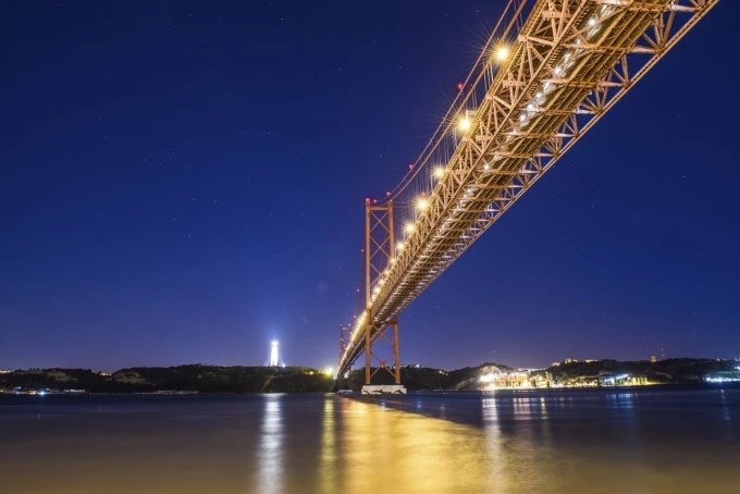 Wall mural of a illuminated bridge against a navy blue sky FP 3106 - Graphic design. Bridge with colored lighting.