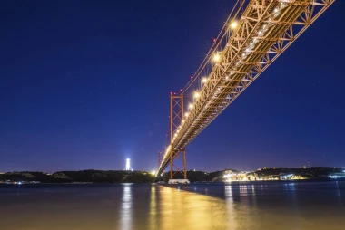 Wall mural of a illuminated bridge against a navy blue sky FP 3106 - Graphic design. Bridge with colored lighting.