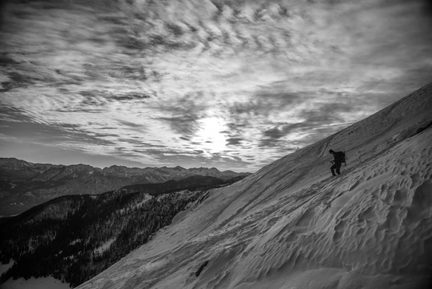Winter wall mural of a lone traveler climbing a snowy mountain, graphic design FP 3140.