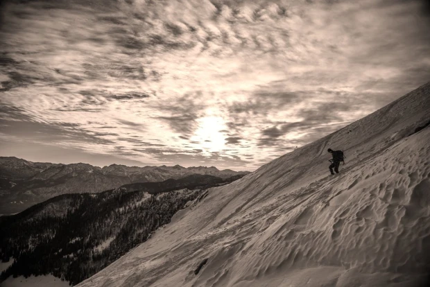 Wall mural of a lone traveler in winter FP 3140 - Graphic design featuring a figure on a mountain slope in a snowy landscape.