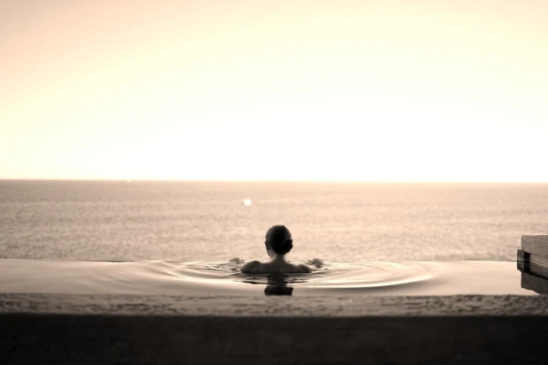 Wall mural of a woman in a pool FP 3150 - Designed for relaxation spaces. Subtle colors, minimalist style.