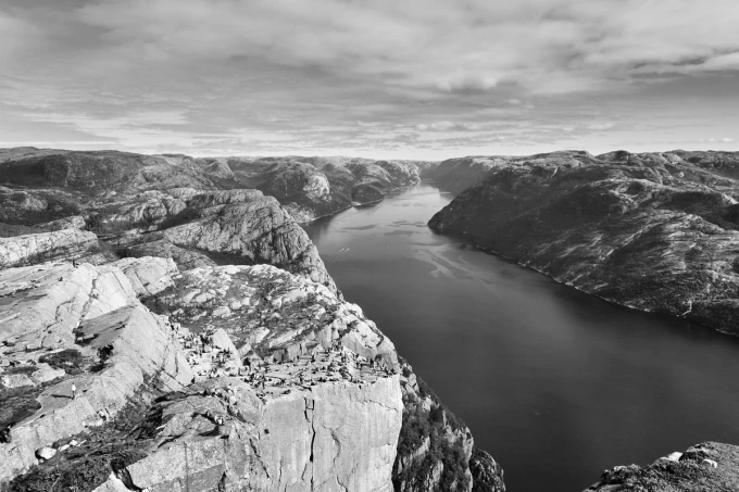 Wide wall mural FP 3154 - Graphic design of a river surrounded by mountains with gentle waves on the water.