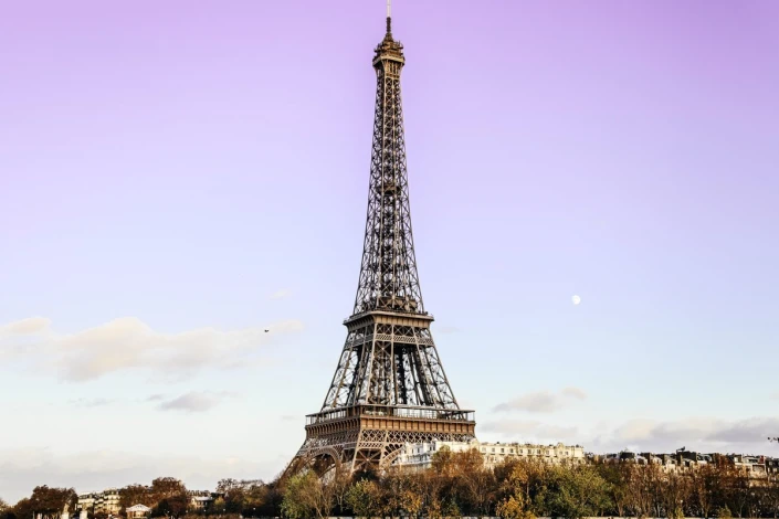 Eiffel Tower wall mural against a pastel sky - Graphic design. Eiffel Tower with sky shades.