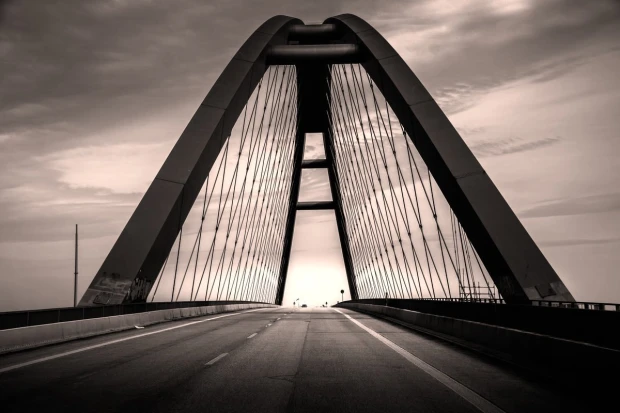 Wall mural of an empty bridge at sunset FP 3530 - Graphic design featuring large arches and cables in soft hues.