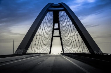 Wall mural of an empty bridge at sunset FP 3530 - Graphic design with large arches against a colorful sky.