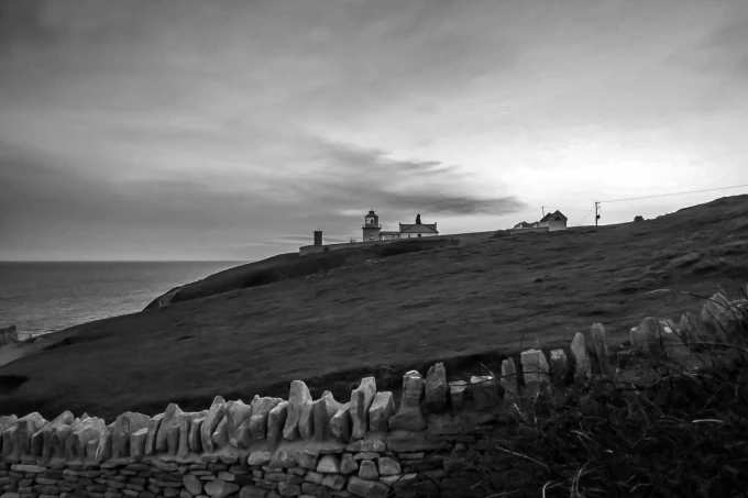 Durlston FP 3935 wall mural featuring a lighthouse on a hill by the sea, styled in a living room.