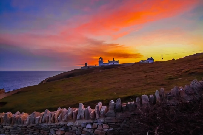 Durlston FP 3935 wall mural featuring a landscape with hills, sea, and a lighthouse in the background.