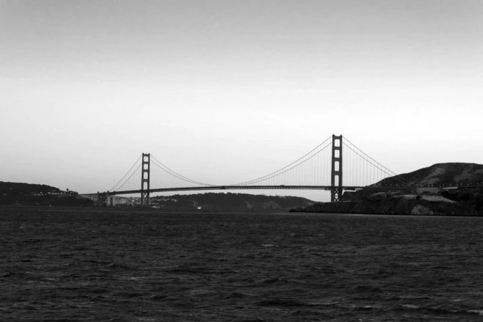 Wall mural of the Golden Gate in the distance FP 4129 - Graphic design featuring the iconic towers and cables against water.