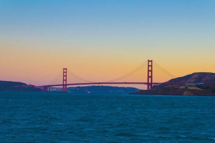 Wall mural Golden Gate in the distance FP 4129 - Graphic design. Red bridge against a blue sky backdrop.