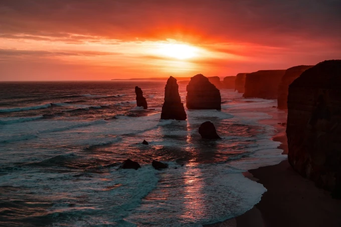 Wall mural summer sunset FP 4196 - Graphic design featuring rocks in the sea and a setting sun.