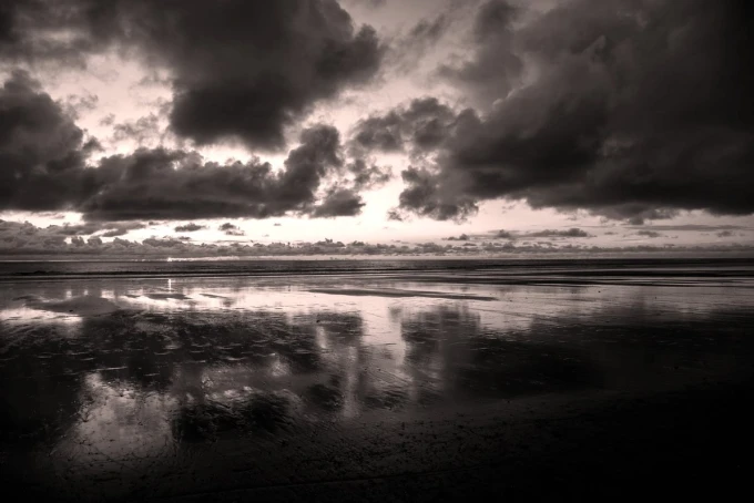 Wall mural of a cloudy sunset FP 4309 - Graphic design featuring dark clouds over water, reflecting light.