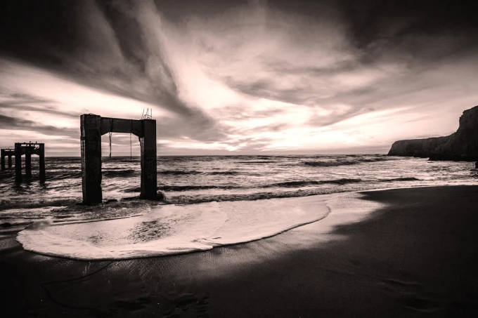 Wall mural of a bridge remnant on the island FP 4424 - Graphic pattern. Bridge in a monochromatic landscape.