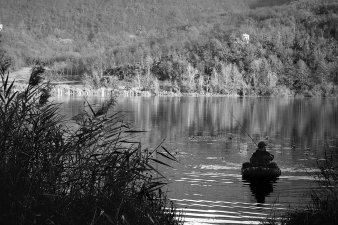 Wall mural of a fisherman at an autumn lake FP 4517 - Living room decor. Scene in shades of gray with a fisherman.