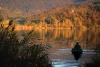 Wall mural of a fisherman on an autumn lake FP 4517 - Living room decor in warm shades of brown and green.