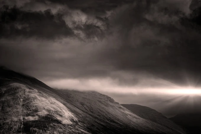 Sunset wall mural FP 4608 - Graphic design. Dark hills with rays of light and clouds.