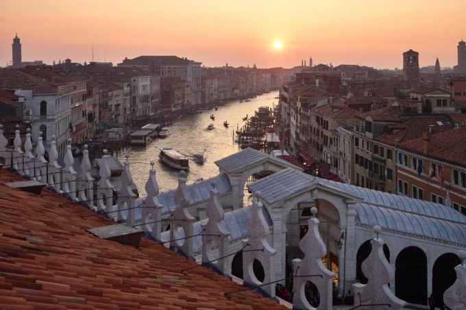Wall mural of a sunset in Venice FP 4663 - Living room decor. Warm shades of orange and pink against the water.