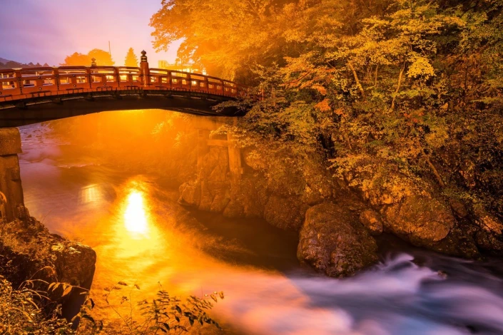 Wall mural of a fairy-tale sunset FP 4677 - Graphic design featuring a bridge over a river surrounded by trees and light reflection.