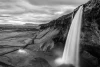 Rocky waterfall wall mural FP 5154 - Graphic design. Water cascades from a high cliff surrounded by mountains and clouds.
