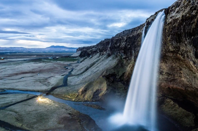 Rocky waterfall wall mural FP 5154 - Graphic design. Water cascades from a high cliff in a mountainous setting.