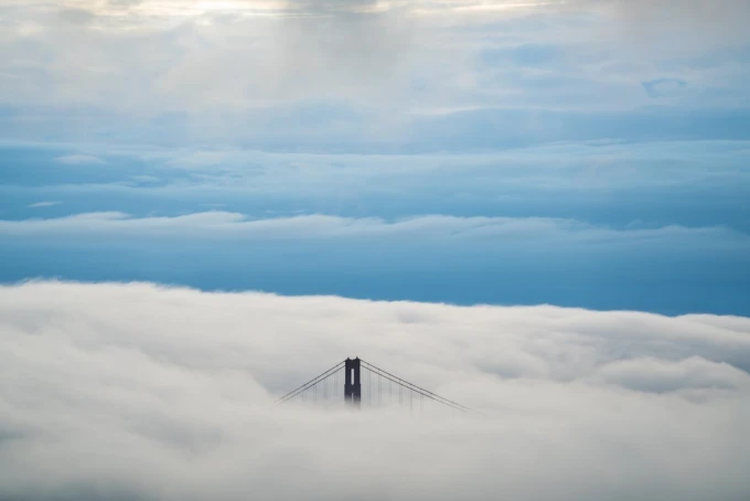 Wall mural of a bridge above clouds FP 5347 - Graphic design featuring a bridge rising above dense clouds against the sky.