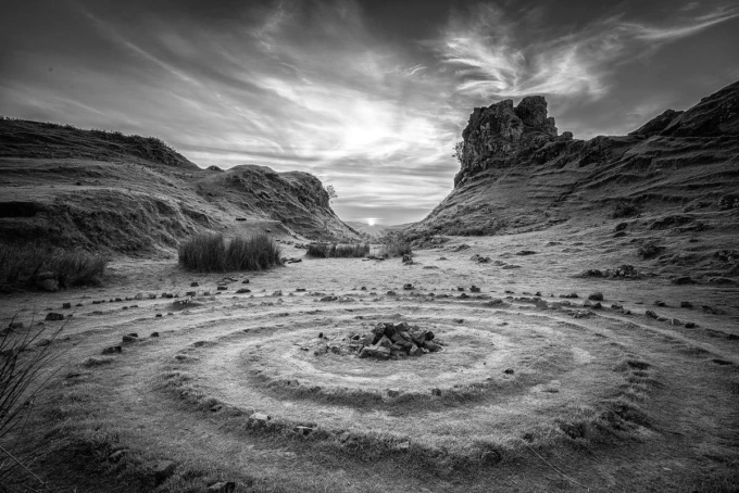 Green meadow wall mural FP 5345 - Graphic design featuring circles on grass surrounded by stones in a natural landscape.