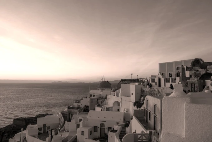 Wall mural of a windmill in Santorini FP 5415 - Graphic design featuring white buildings and the sea in the background.