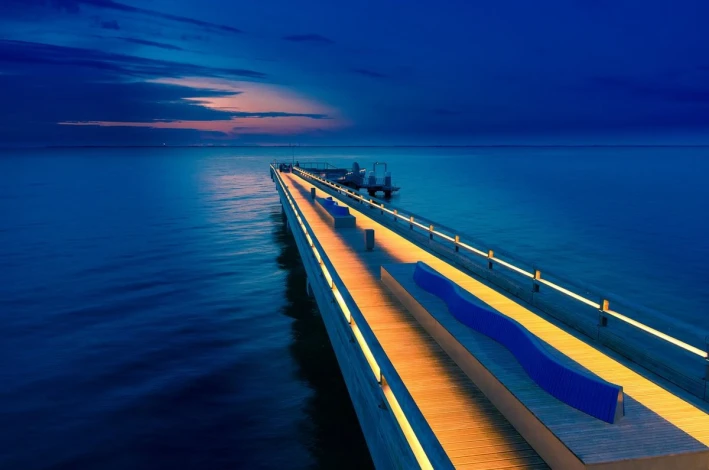 Wall mural of a pier at night FP 5444 - Modern interior design with blue-toned walls.