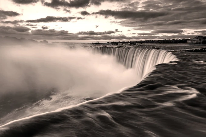 Wall mural of an extraordinary waterfall FP 5455 - Graphic design. Water cascades from the edge, surrounded by mist and clouds.