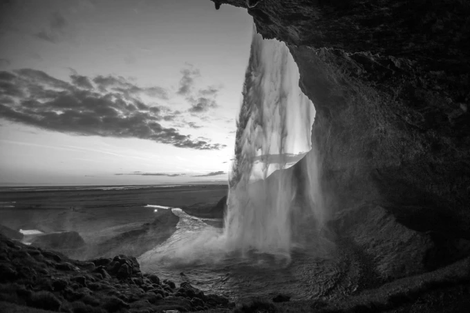 Wall mural waterfall sunset FP 5651 - Graphic design. Water cascades from a high rock, surrounded by dark scenery.
