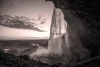Wall mural waterfall sunset FP 5651 - Graphic design. Water cascades from a high rock, surrounded by shades.