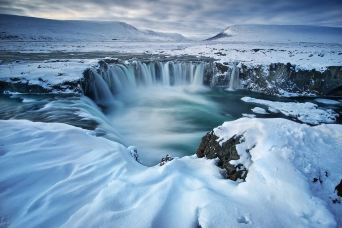 Wall mural of a snowy waterfall FP 5746 - A graphic design featuring water cascading amidst snow and rocks.