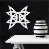Abstract painting stencil 2244 - Living room setup with dark wall, white pattern, and simple table.