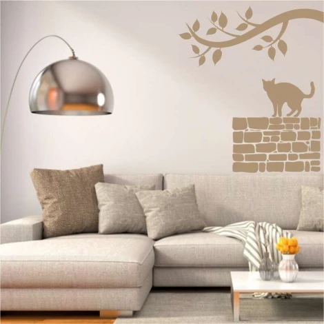 Cat painting template on a wall - Living room setup. Light-colored walls, gray furniture.