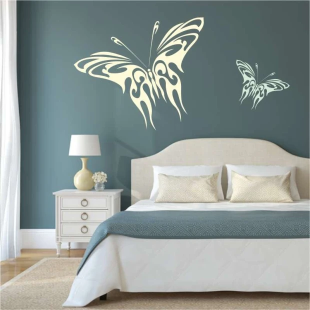 Butterfly wall template 2359 - Bedroom decor with blue walls and a bed featuring light bedding.