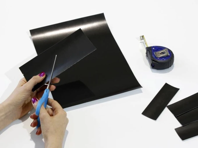 Self-adhesive steel foil A4 sheet - Graphic pattern. Black rectangles cut with scissors.