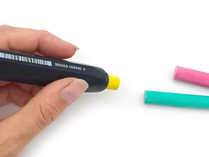 Chalk holder with graphic design. Rectangular shape with two pieces of chalk in different colors.