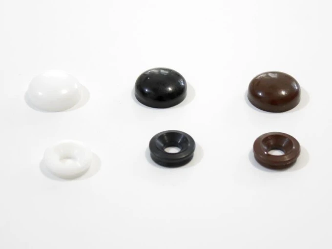 Mounting system for concrete-brick - Graphic design. Six round pieces in three colors: white, black, brown.