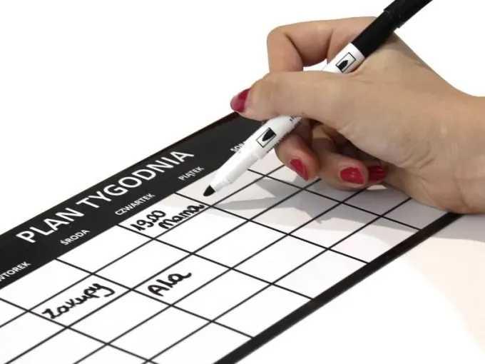 Custom dry-erase magnetic board with graphic design. Black rectangle with white lines and text.