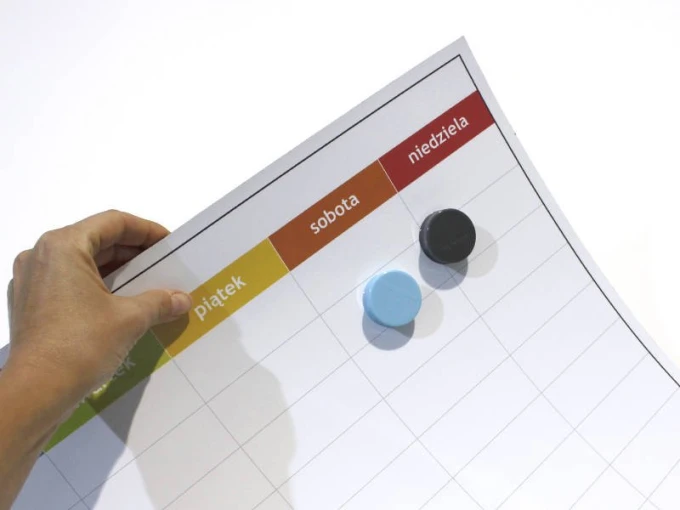 Magnetic dry-erase weekly planner board with time slots and a graphic design featuring a weekly grid.