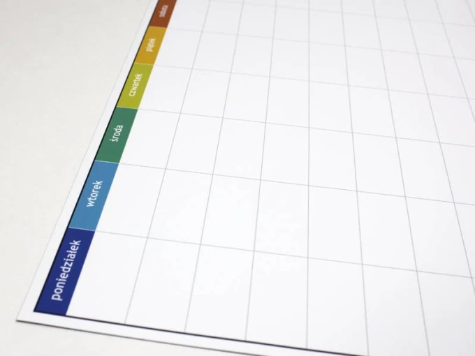 Magnetic dry-erase weekly planner board - Simple grid design with days of the week in various colors.