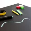 Magnetic black chalkboard, perfect for creative notes in a modern office.