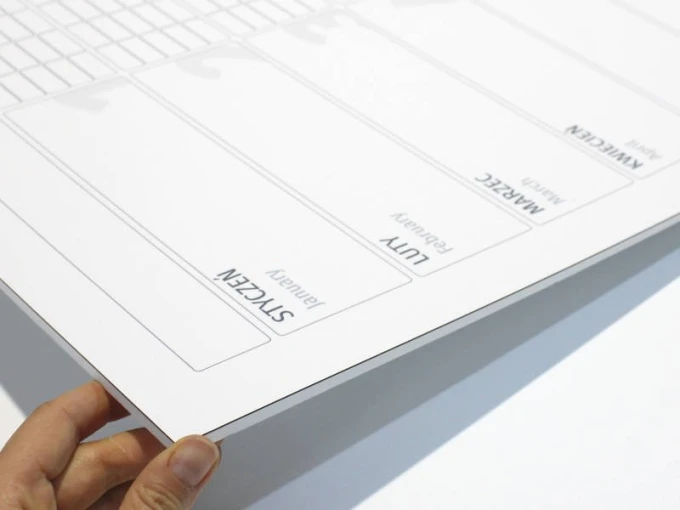 Magnetic dry-erase calendar board, universal yearly design with a simple grid for monthly sections.
