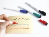 Dry-erase marker with eraser Tom TO-268 - Graphic design. Colorful waves visible on a yellow surface.