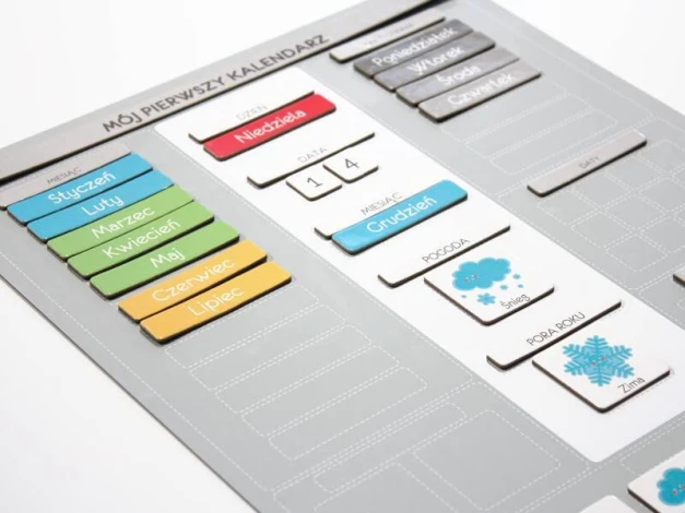 Children\'s calendar with magnets featuring graphic design of rectangular pictograms for months and days of the week.